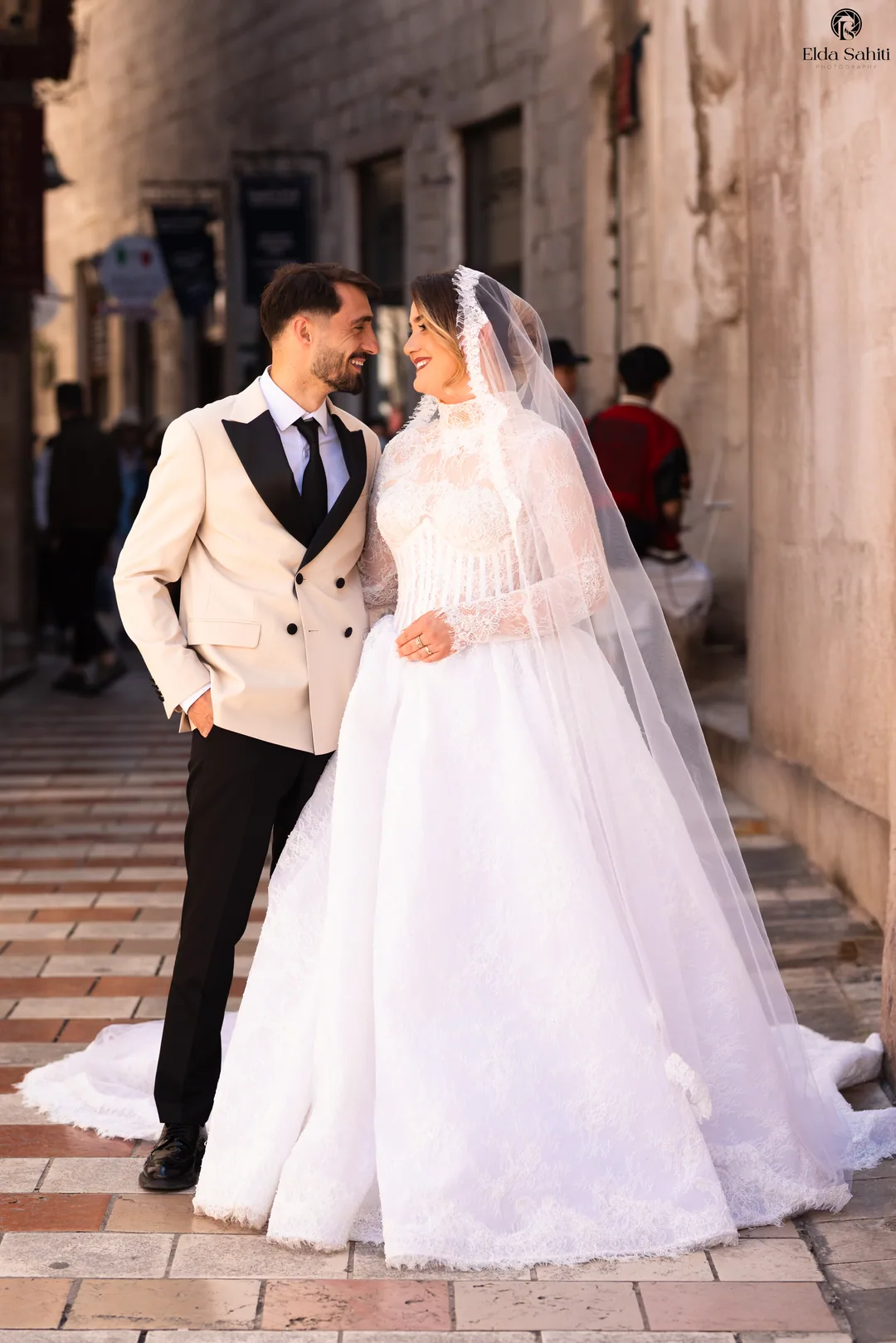 Couple smiling at each other in a narrow stone alley