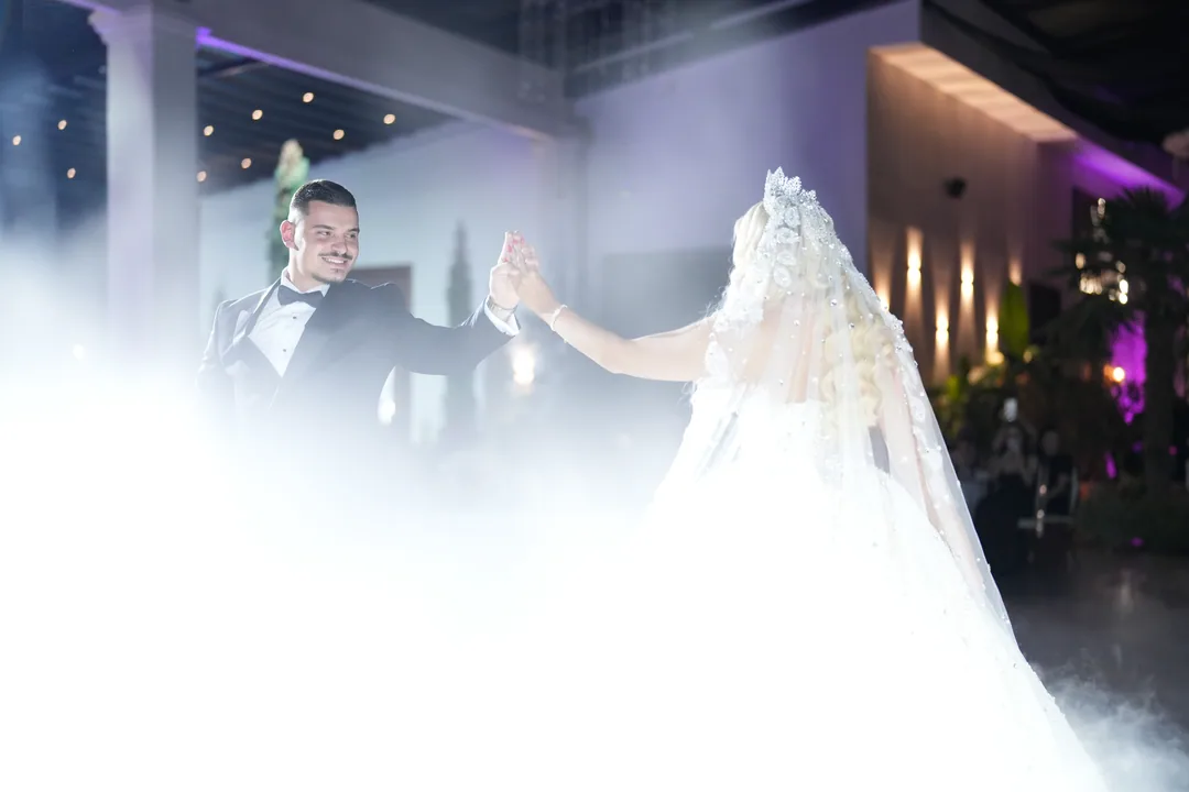 First dance in rolling fog, purple light on the walls behind