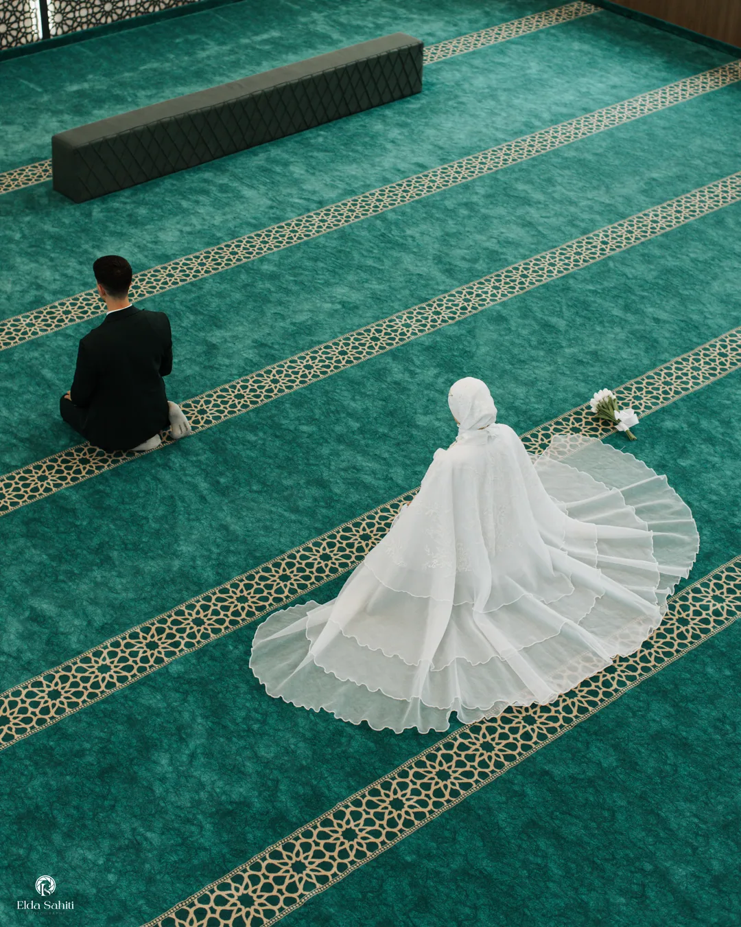 From above: the groom in prayer and the bride's train spread across the green mosque carpet